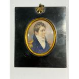 A Mid-19th century oval portrait miniature of a Naval Commander, with brown wavy hair with side