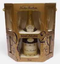 A commemorative Millenium magnum bottle of Nicolas Feuillatte champagne, with a set of 12 flutes, in