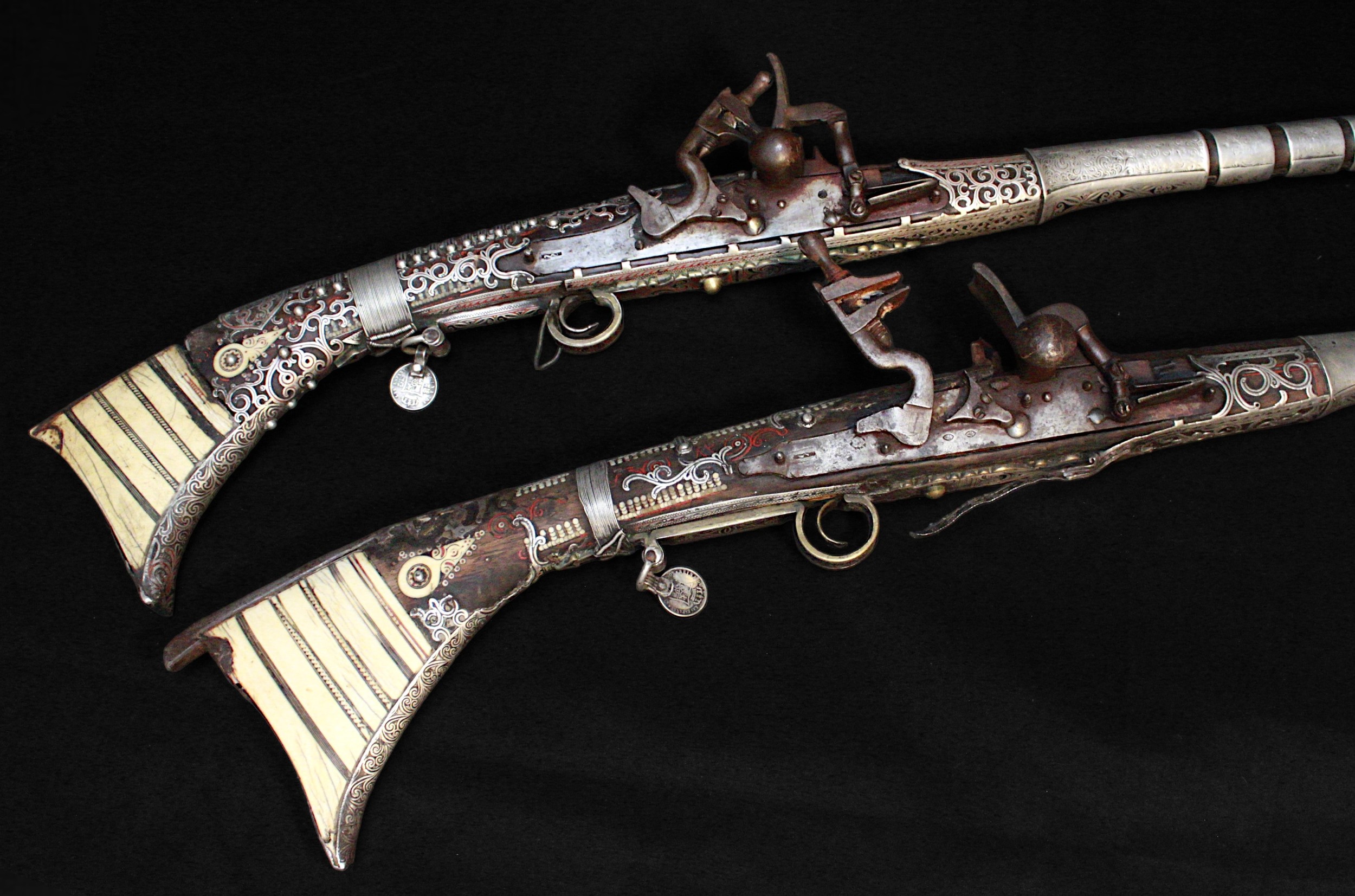 A near pair smooth bore 18th/19th century Arab snaphaunce Jezail, approximately 64” overall, with