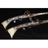 A near pair smooth bore 18th/19th century Arab snaphaunce Jezail, approximately 64” overall, with