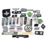 A collection of mostly German Third Reich insignia, patches, officer shoulder and collar boards,