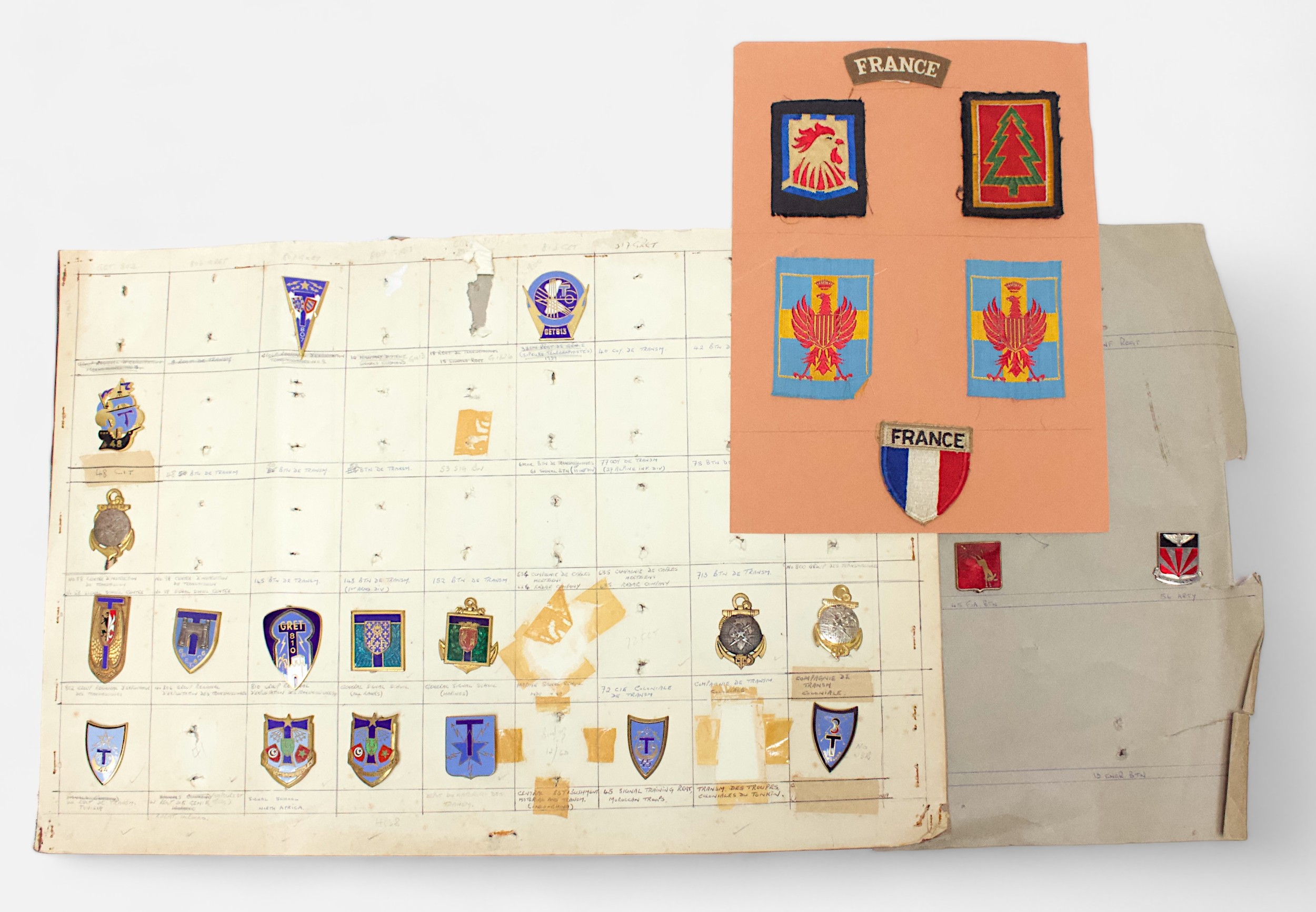 Fifteen card sheets displaying a good collection of assorted cap badges and patches including