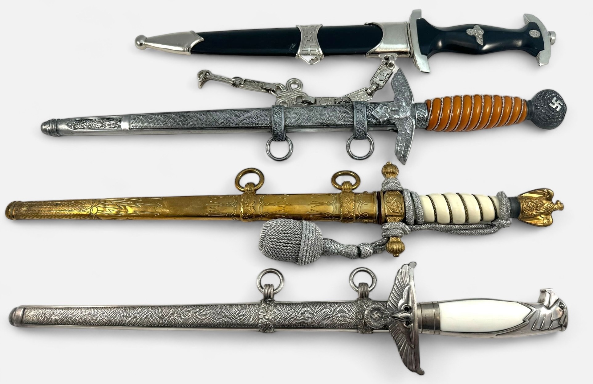 Four reproduction German Third Reich Dress Daggers, comprising SS dagger, Kriegsmarine, Army