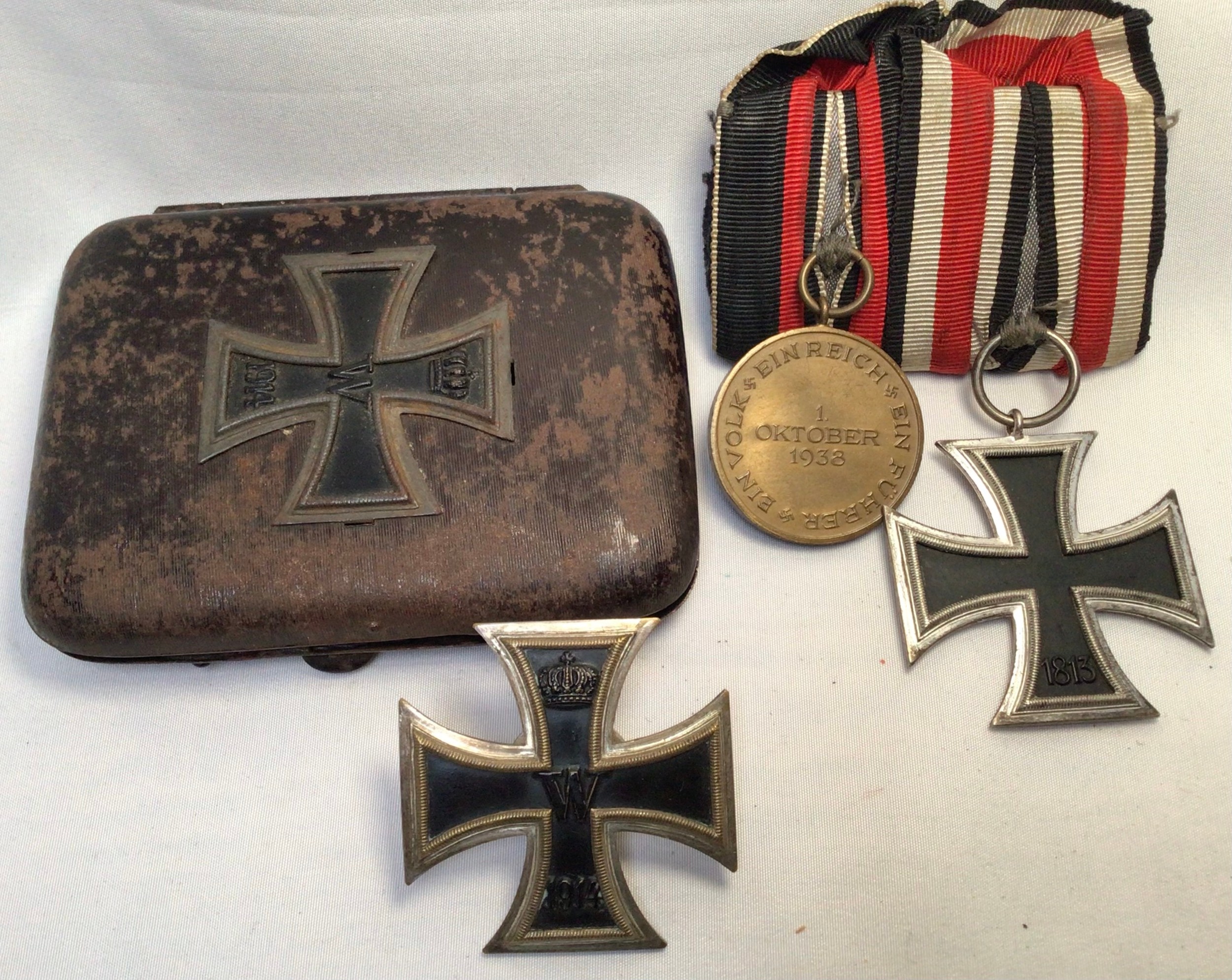 A WWI German Iron cross with crown above ‘W’ above date 1914, with screw on back, together with a
