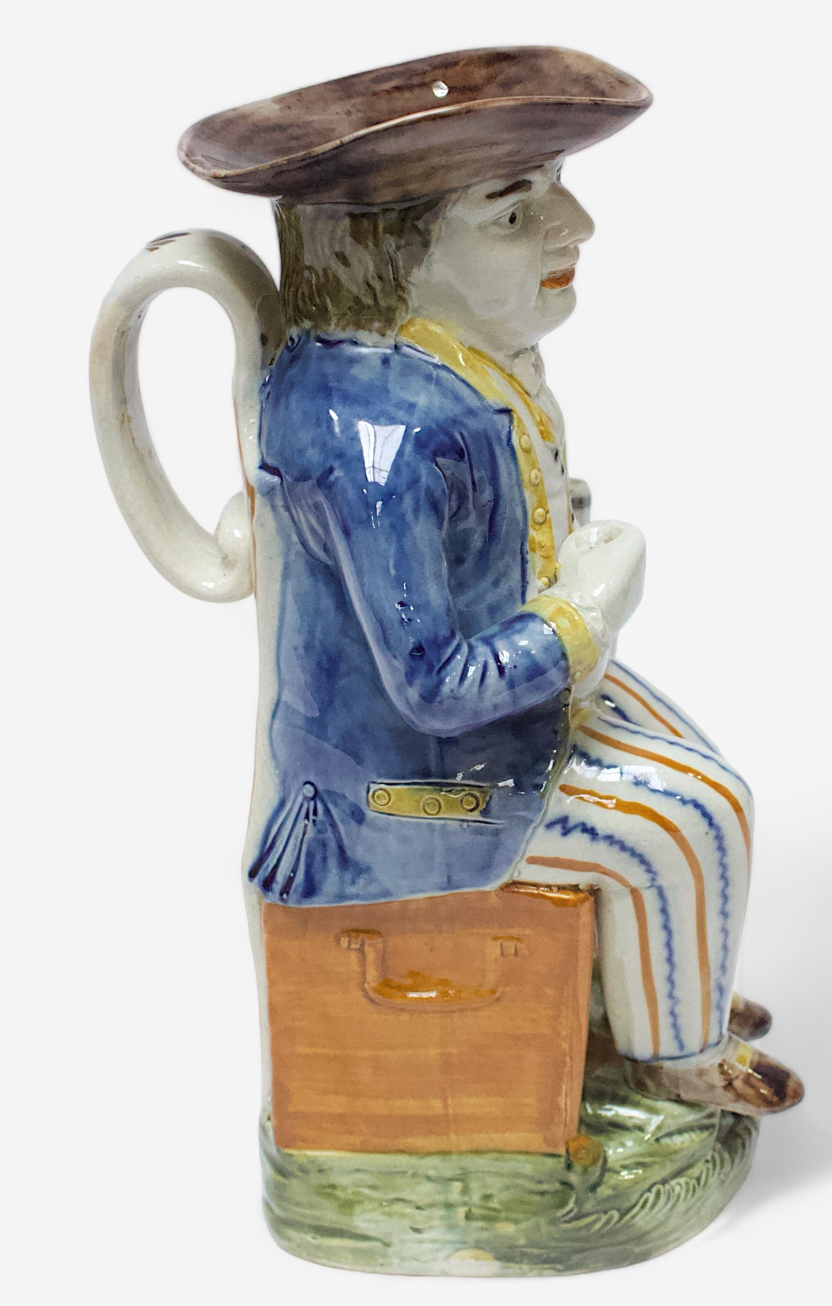A Prattware Pottery ‘Sailor’ toby jug, c1790-1810, seated holding a jug, striped britches, blue coat - Image 2 of 4