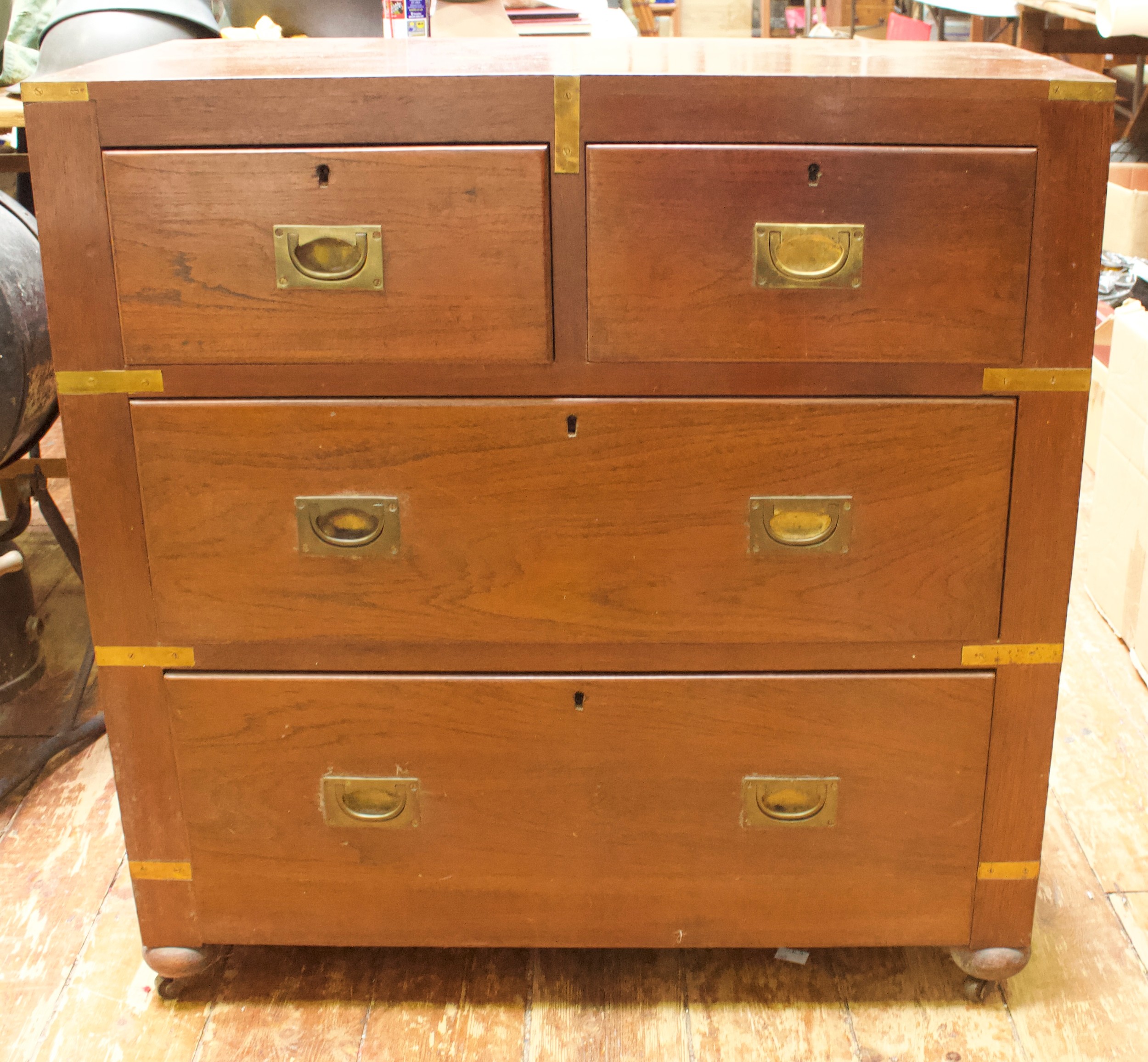 A 19th Century brass-bound teak military chest of two short and two long drawers with flush brass