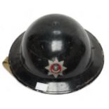 A black painted British WWII fire brigade steel helmet, with decal to front, numbered 431194 to