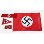 A WWII German Third Reich Swastika pennant, together with an armband, another felt armband and flag.