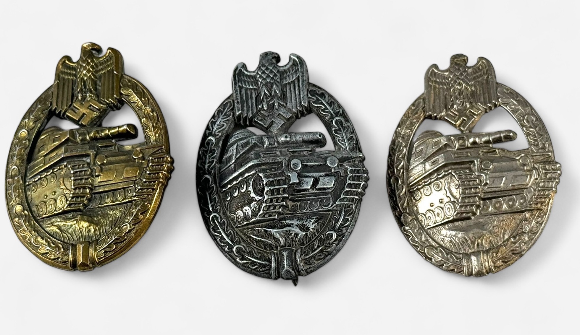 Three various WWII German Third Reich Panzer Assault badges, brass-plated alloy example with cast SA