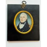 An early 19th century oval portrait miniature of a middle-aged Naval officer, with reseeding grey