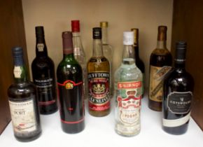 A collection of ten bottles of various vintage wines and spirits, comprising Smirnoff Vodka 26 2/3