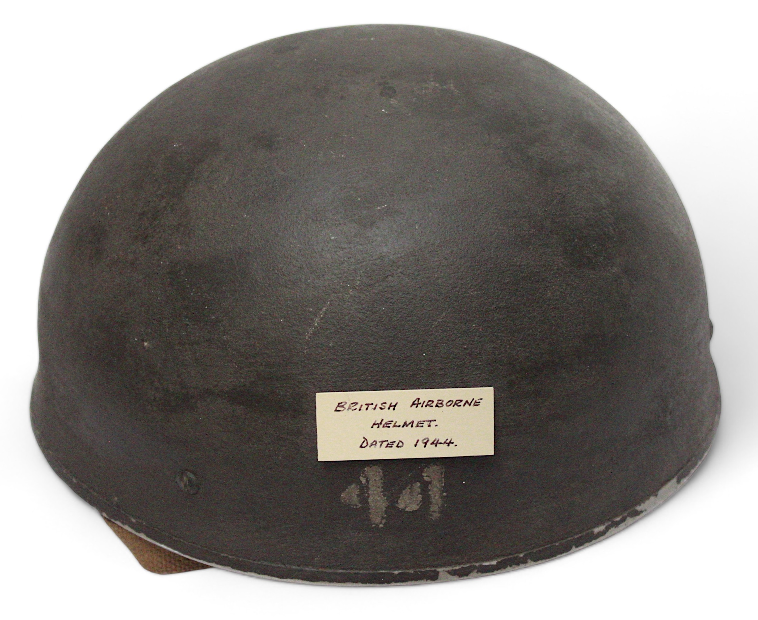 A WWII British Airborne Paratrooper's steel helmet, with webbing chinstrap, leather liner stamped
