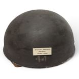 A WWII British Airborne Paratrooper's steel helmet, with webbing chinstrap, leather liner stamped