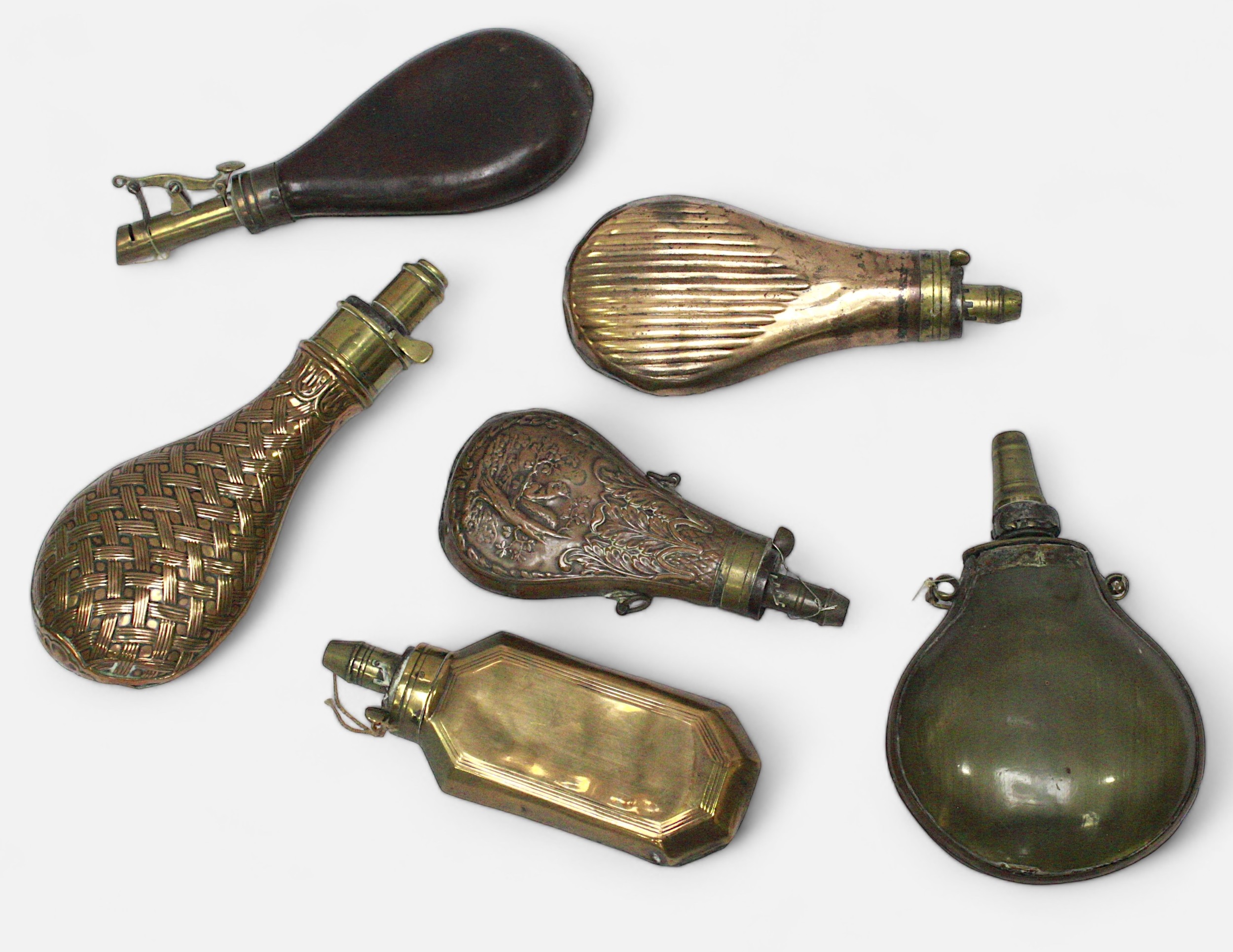 Six various powder flaks, including three pressed sheet brass, one leather and one horn example. ( - Image 2 of 2