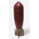 A large WWII aerial 'Practice Bomb,' outer casing painted red, marked ‘IP42’, with brass four-