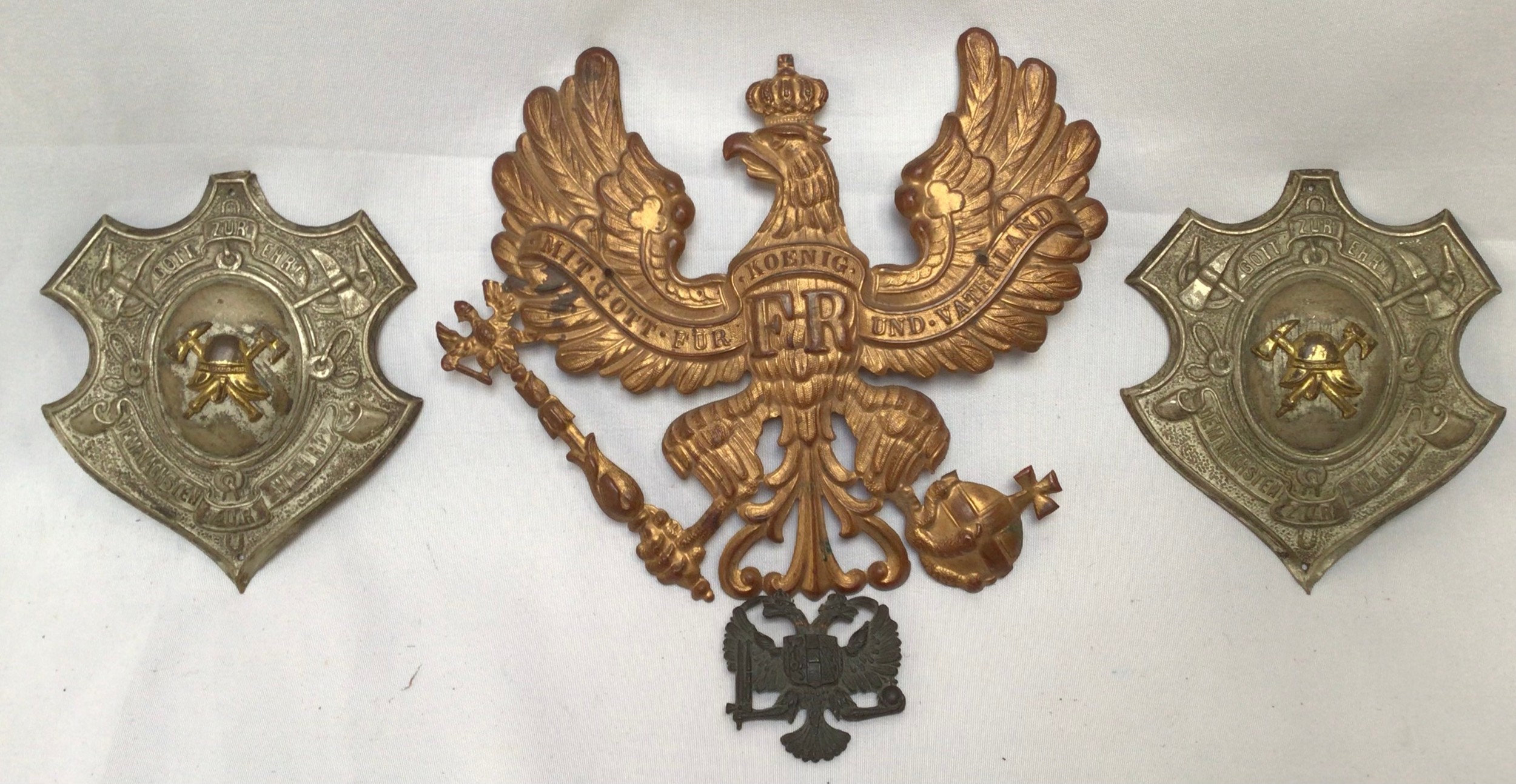 A Prussian Imperial German Infantry Officer’s Pickelhaube helmet brass plate, together with a pair