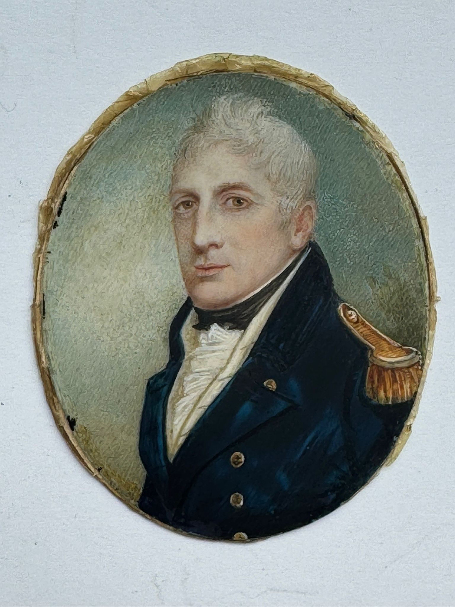 An early 19th century oval portrait miniature of a middle-aged Naval officer, with quiffed grey - Image 2 of 2