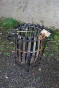 A fire basket, 20" high x 16" diameter.
