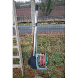 A hose on a reel and two pairs of oars/paddles.