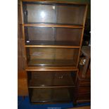 A Simplex 1960s Teak/Mahogany sectional bookcase with glazed sliding doors, 3' x 14" x 78" high.