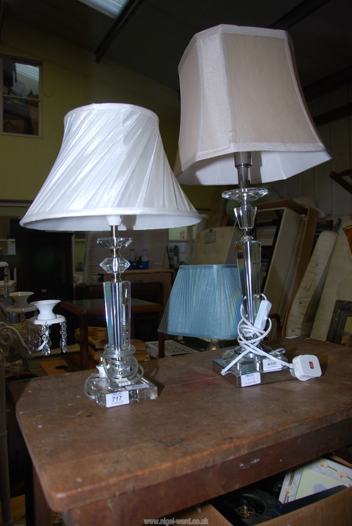 A pair of glass table lamps with shades.