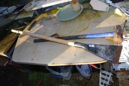 A sledge hammer with fibreglass handle and a long wooden handled scraper.