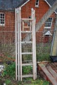 A wooden decorator's ladder with three section extension