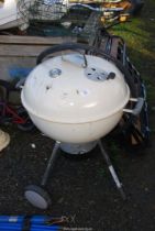 A white Webber kettle BBQ.