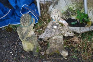 Two concrete figures; boy with fish 17 1/2" high and sitting lady 15" high.