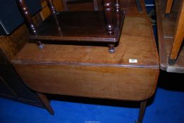 A cross-banded Mahogany Pembroke table standing on tapering square legs and having a frieze drawer