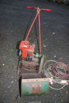 A Suffolk cylinder mower, engine turns.