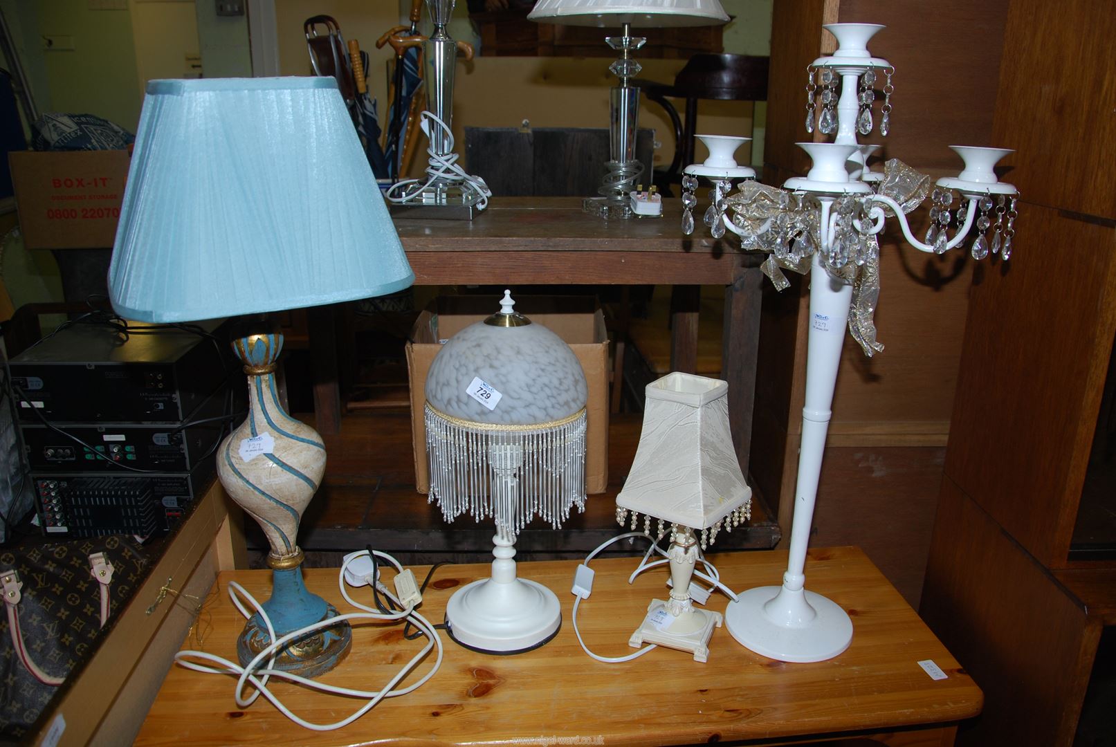 Three table lamps and a candelabra.