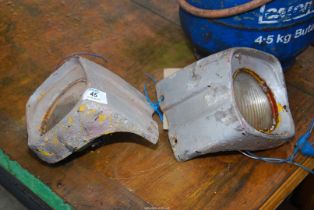 A pair of old style aluminium Massey Ferguson head lamps.