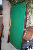A small pool table, 38'' x 72'', plus rest and two cues.