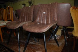 Two mottled brown faux-leather side chairs.
