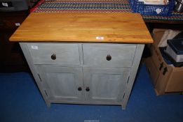 A small painted based cupboard with an Oak top and two frieze drawers.