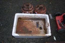 A long Belfast sink and two cartwheel hubs.