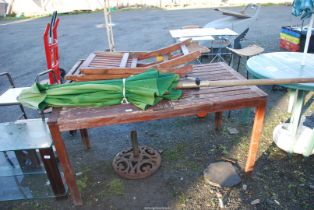 A Teak table, parasol and stand and two chairs.