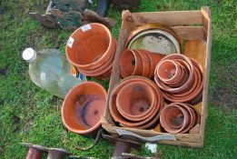 A quantity of clay pots in various sizes.