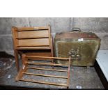 A brass magazine rack and two wooden racks.