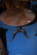 An Oak circular snap-top tavern table standing on a turned pillar with three splay feet,