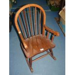 A child's Rocking Chair, 28'' high, seat height 11 1/2'', (some damage to arm joint).