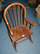 A child's Rocking Chair, 28'' high, seat height 11 1/2'', (some damage to arm joint).