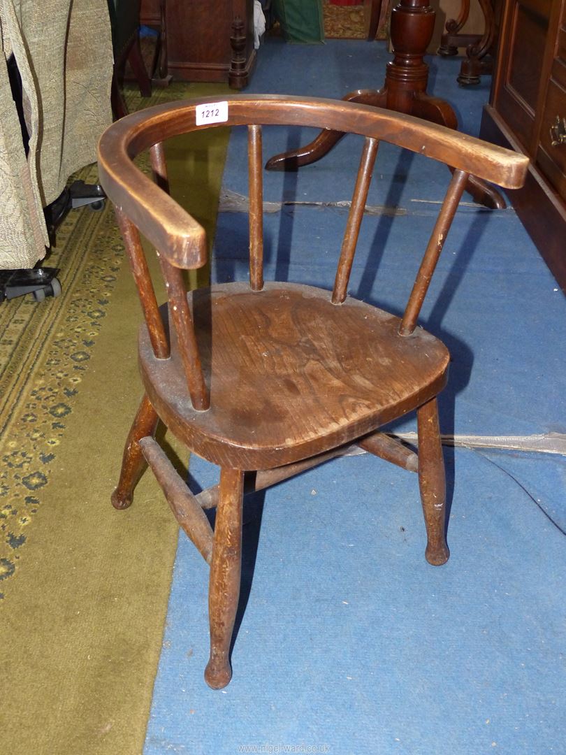 A vintage child's carver chair. 20 1/2'' high, 12'' high seat.