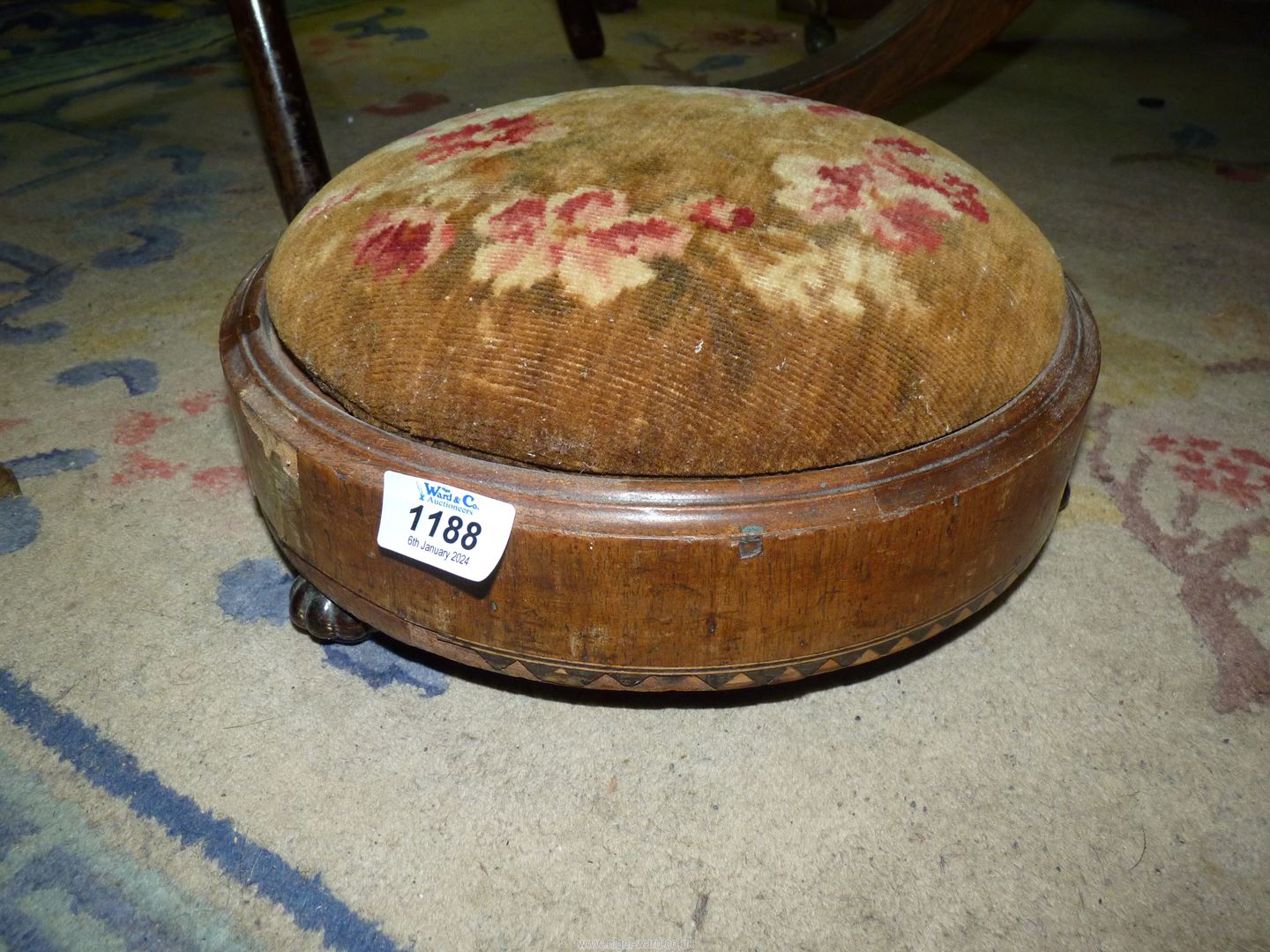 A low circular footstool.