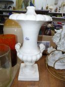 A white china lamp base with ram head handles, 17'' high, some wear.
