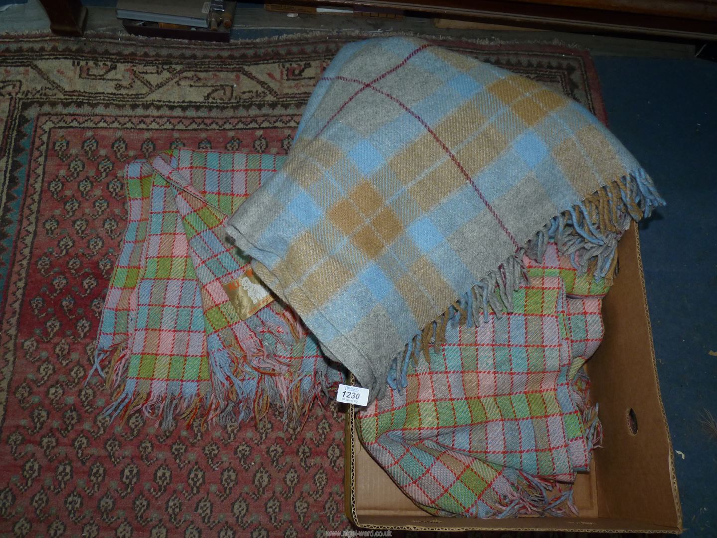 Four all wool travel rugs in multicoloured checks.