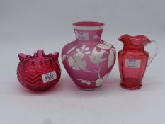 A cranberry glass jug and bowl (not matching) and a pink glass vase with hand painted decoration of