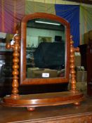 A 19th century light mahogany swing mirror with bobbin turned supports and pill feet, 20" x 20".