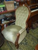 A circa 1900 Satinwood framed open armed Fireside Chair standing on scroll front legs and